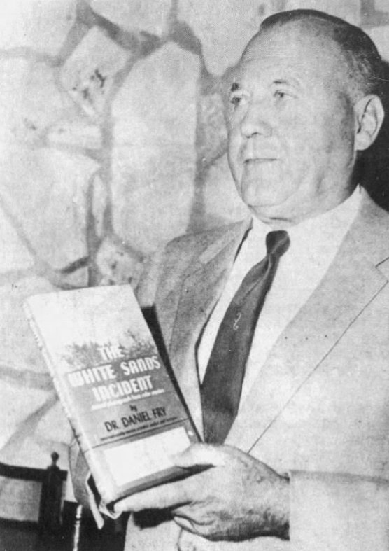 Daniel Fry holding a copy of his book, photographed in 1967