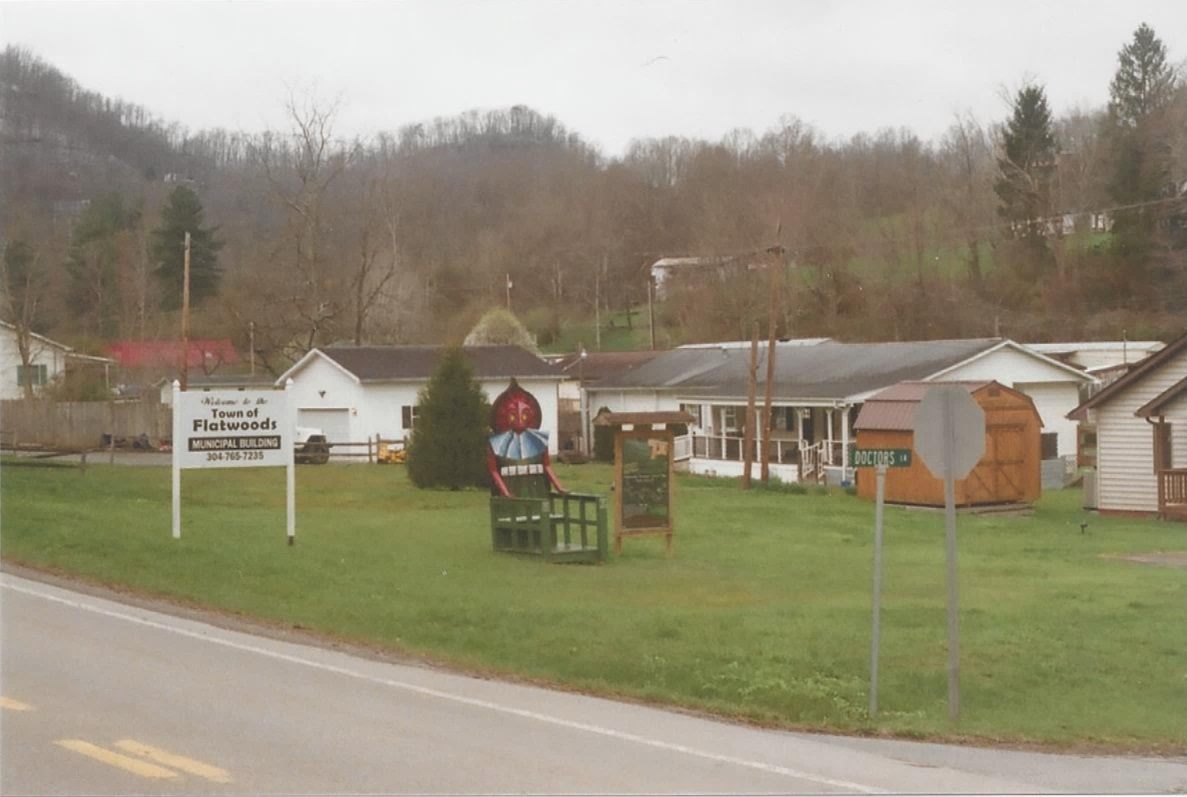 Sign and monster chair sculpture marking the Flatwoods Monster site near the town hall in Flatwoods, Braxton County, West Virginia