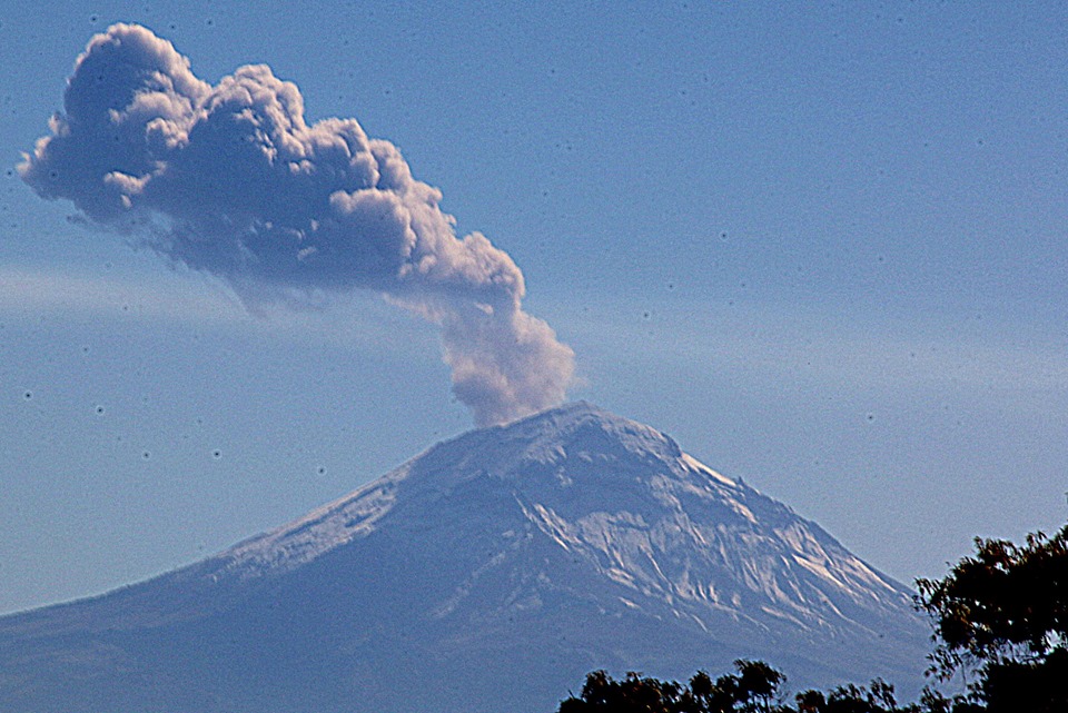 Popocatépetl volcano erupting, December 2018, ash and steam column visible over the crater
