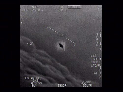 ATFLIR infrared frame from the 'Gimbal' video, the Pentagon-declassified January 21, 2015 U.S. Navy encounter recorded by an F/A-18F Super Hornet of the USS Theodore Roosevelt Carrier Strike Group, showing the tracking reticle locked on the dark oblong object above a cloud layer